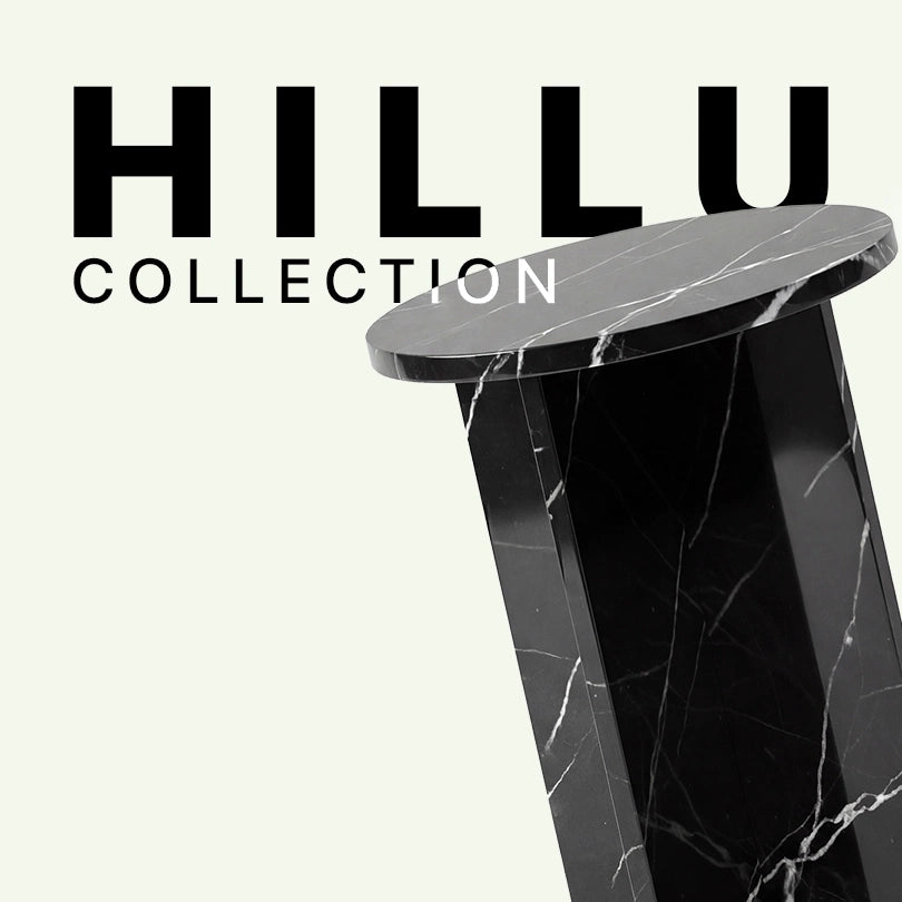 Werbegrafik für den Hillu Beistelltisch aus schwarzem Nero Marquina Marmor. Das Bild zeigt eine Nahaufnahme der runden Tischplatte und des markanten, überkreuzten Standfußes mit feinen weißen Adern vor dem „Hillu Collection“ Schriftzug.