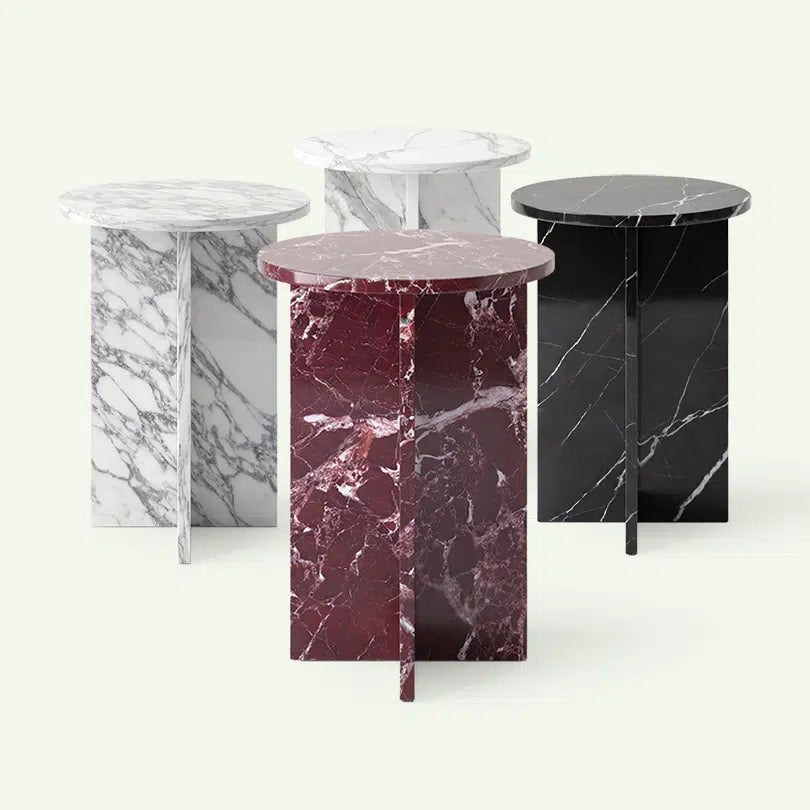 Frontale Übersicht der Hillu Marmor-Serie. Im Fokus steht die Variante aus Rosso Levanto, im Hintergrund sind die Modelle in Arabescato, Calacatta White und Nero Marquina zur Darstellung der Kollektionsvielfalt aufgereiht.