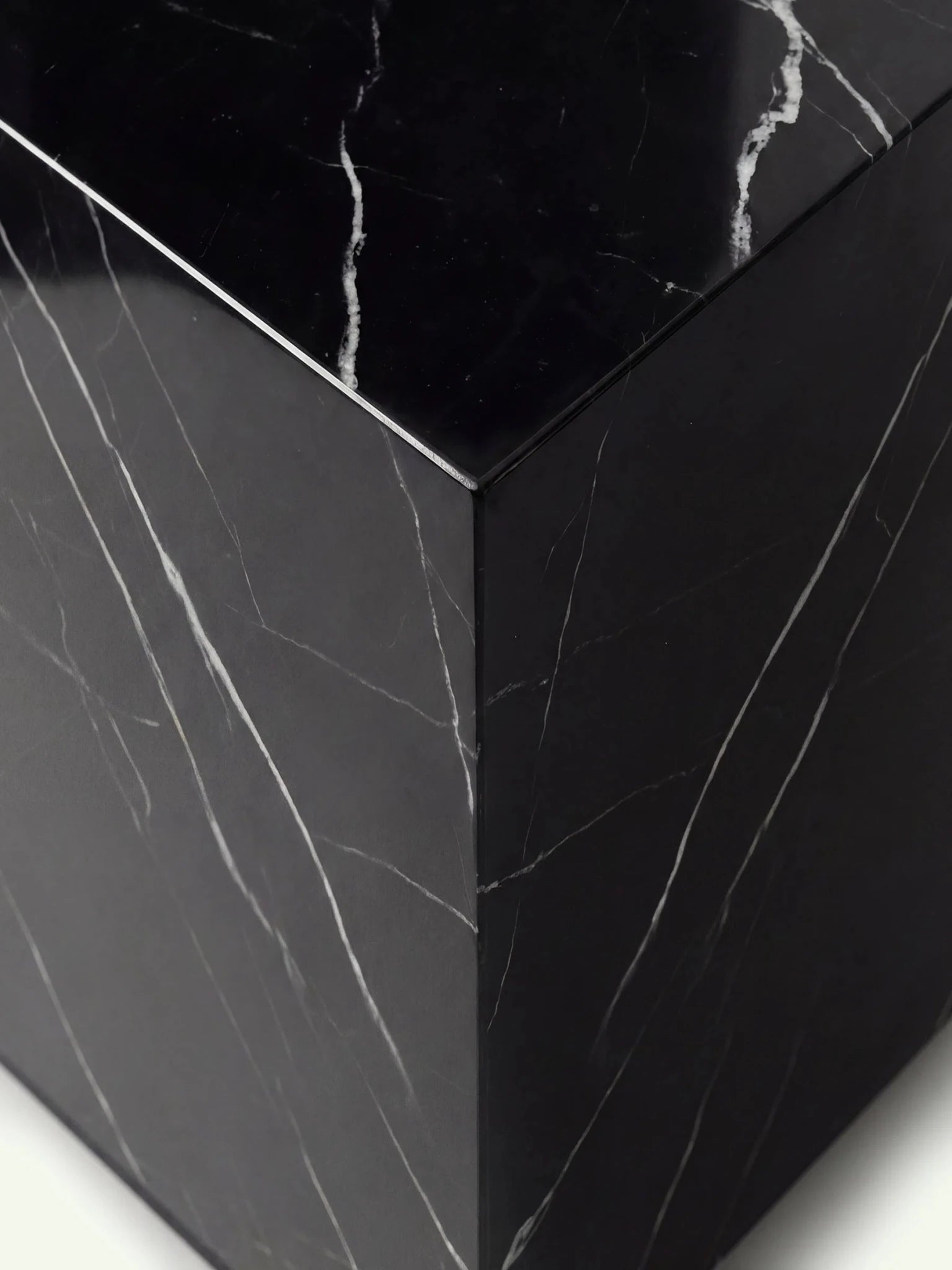 Nahaufnahme der oberen Ecke des Modells Pella, die die hochwertige Verarbeitung des Nero Marquina Marmors zeigt.